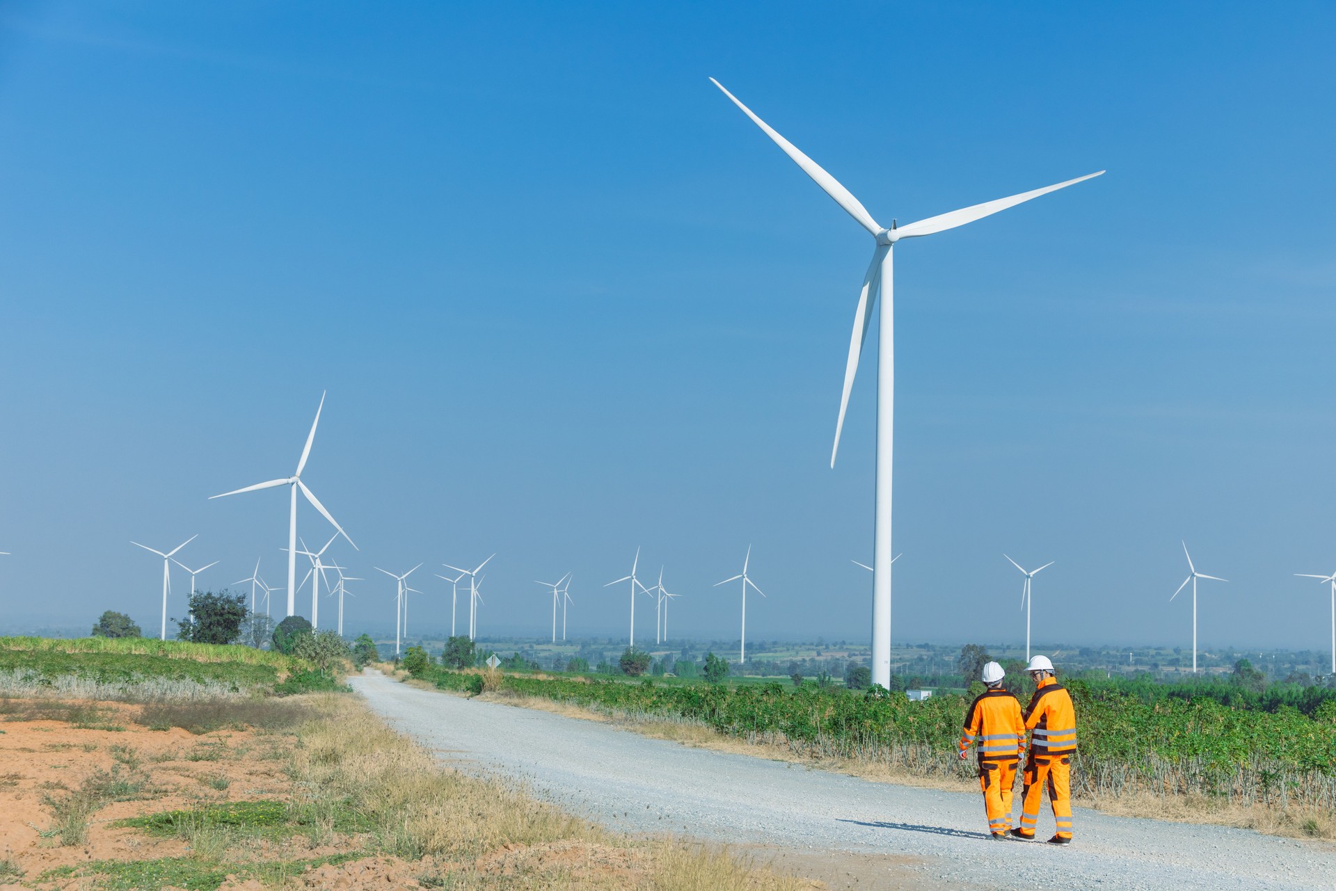 Engineer workers teamwork working together service maintenance wind turbine clean power green energy
